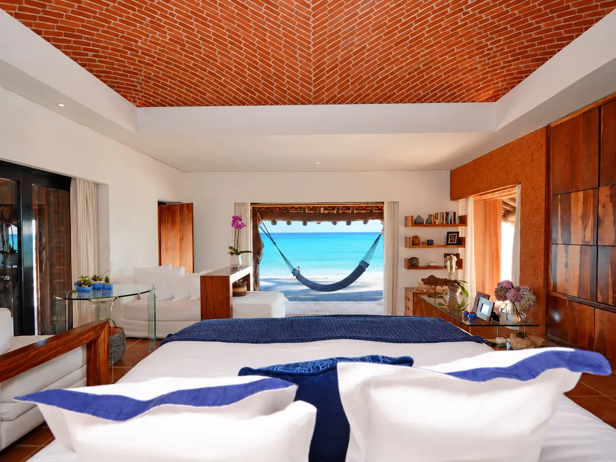 A bedroom at Casa Corazon with a brick dome ceiling and an ocean-view hammock