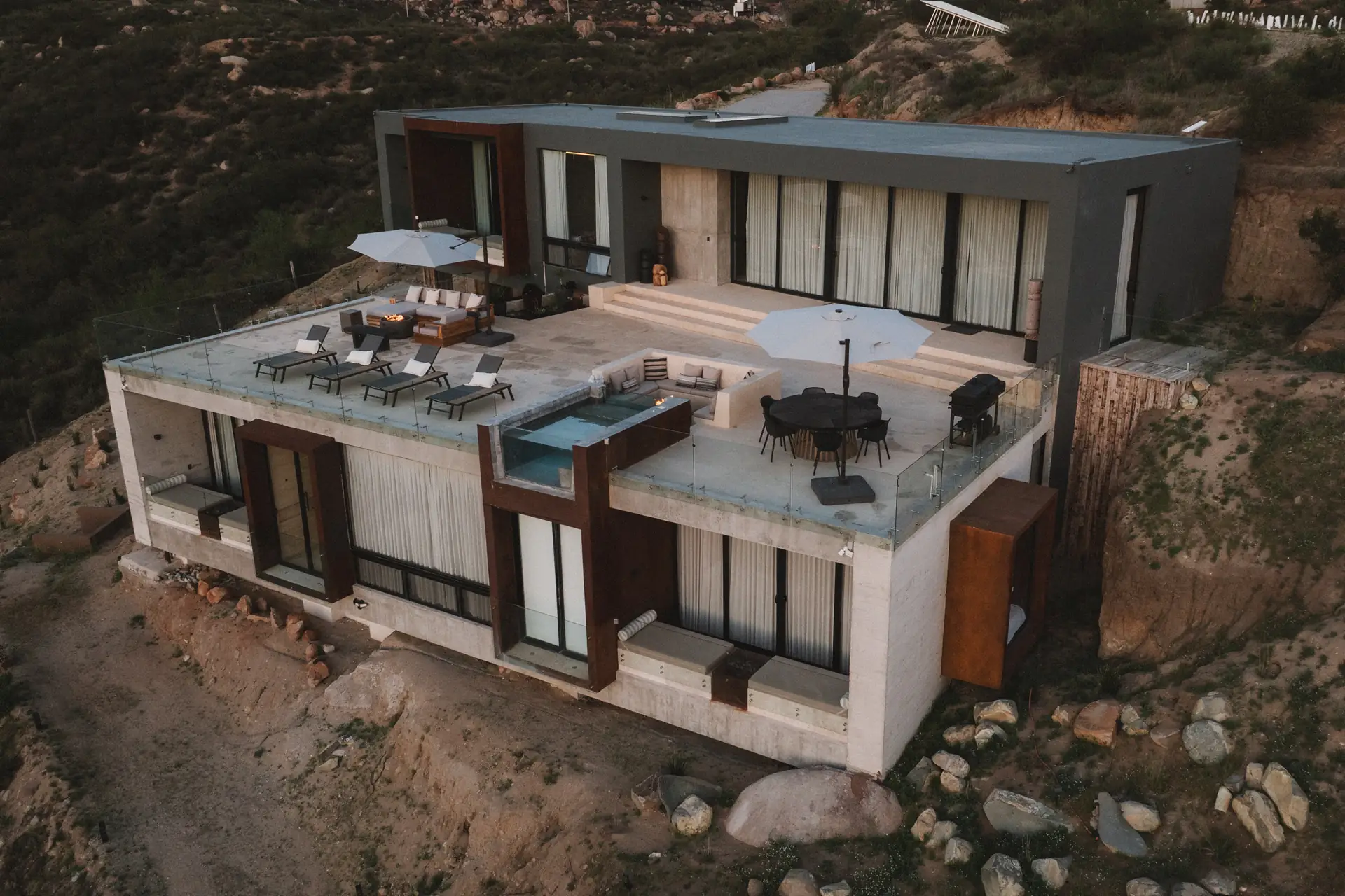 Aerial view of the rooftop terrace with sun loungers, dining table and plunge pool at Kasa Kefi
