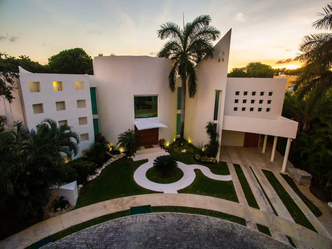 Villa Aqua's sculptural architecture glowing at dusk